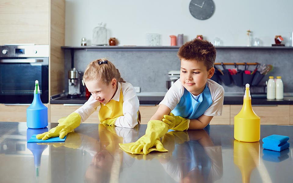 Children cleaning counter top